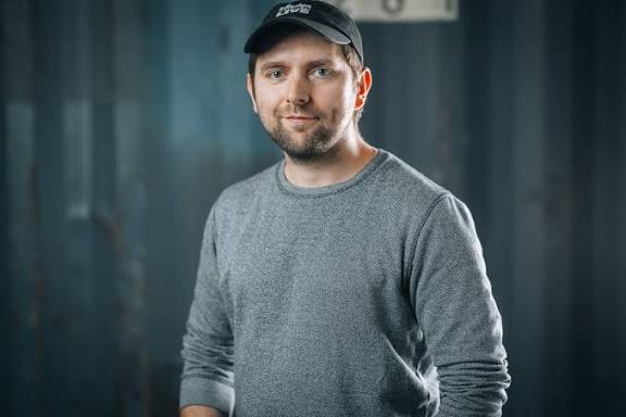 Adam Wolke in einem grauen Pullover